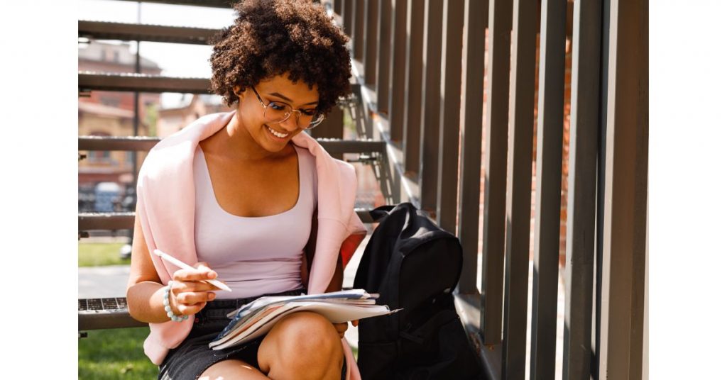 Mulher estudando sentada na escada